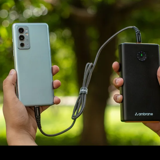 A customer holding a smartphone and a power bank.